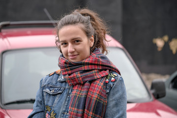 Beautiful attractive girl in a red checkered scarf