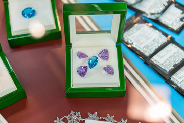 purple and blue jewels in a case. Rubies in a case.