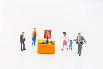 Miniatrue people: Shoppers buy goods on sale with discount tray. Tourism, shopping or business concept.