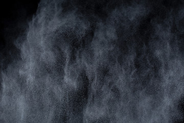 White powder explosion on black background. Colored cloud. Colorful dust explode. Paint Holi.