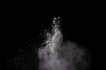 White powder explosion on black background. Colored cloud. Colorful dust explode. Paint Holi.