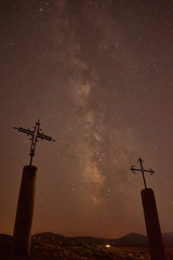 Silhouette of two crosses at night with beautiful milky way background