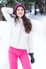Beautiful woman is playing with snow.