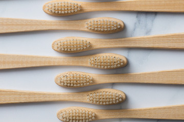 Wooden bamboo toothbrushs on a marble background