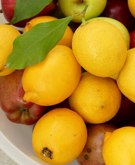 lemon on a leaf, a large amount of natural lemon in a container, yellow lemons,