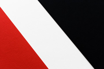 three-color contrast striped background of white black and red paper