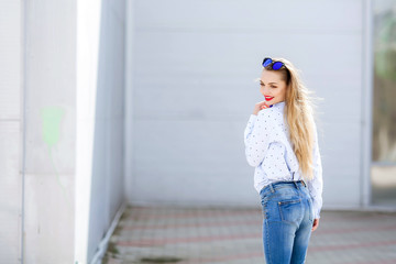 Summer, fashion and people concept - bright stylish portrait pretty woman in sunglasses against colorful wall in the city, street fashion