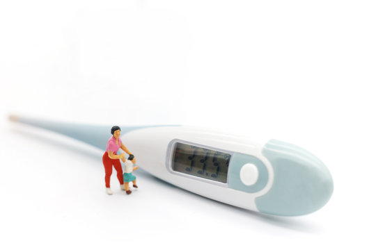 Miniature people: Mother and children meet doctor with thermometer. Health care and business concept.