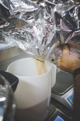 Brewers mixing up yeast in a brewery