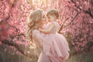 Portrait of young beautiful mother with her little girl. Close up still of loving family....
