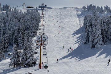 Winter ski resort,ski lift,people skiing. Uludag Mountain, Bursa, Turkey