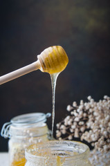 bee honey dripping from a wooden spoon