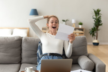 Happy girl reading good news about test results in letter