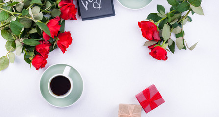 A bouquet of red roses and fresh aromatic tea for a romantic breakfast. Flowers and a letter as a gift. Valentine's day and mother's day concept. Flat lay. Copy space,