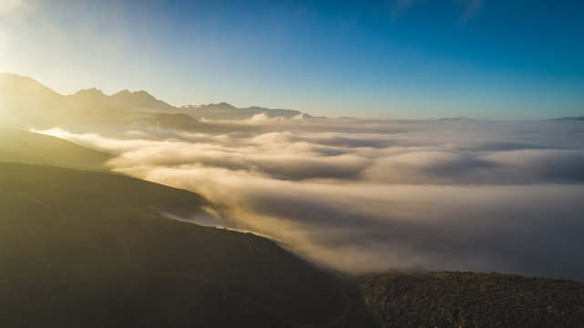 Aerial photo of low clouds / cloud inversion and mountains