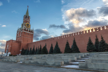 Moscow Kremlin Spasskaya Tower and wall on a beautiful cloudy evening sky background
