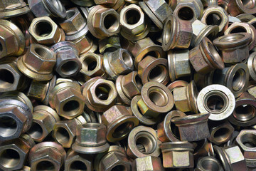 Top view of big pile of screw nuts as background