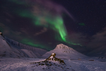 The polar arctic Northern lights aurora borealis sky star in Norway travel Svalbard in Longyearbyen city the moon mountains