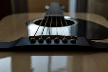 bridge of acoustic guitar. close up