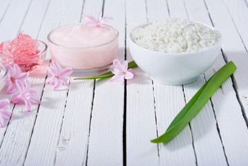 beauty products with hyacinth flowers on white wood