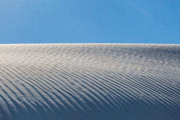 Contrasting white sand and blue sky, in White Sands National Monument, New Mexico