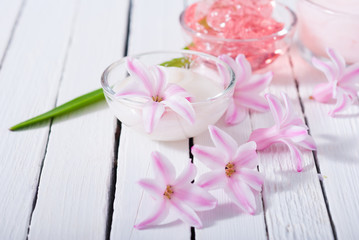 beauty products with hyacinth flowers on white wood
