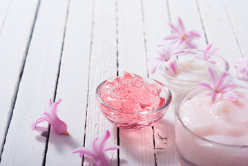 beauty products with hyacinth flowers on white wood