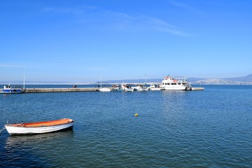 Fototapeta na wymiar View of the pier of Neoi Epivates suburb of Thessaloniki, Greece. Fishing boat in blue sea. 