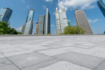 Fototapeta premium Empty square floor tiles and skyline of modern urban buildings in Shanghai..