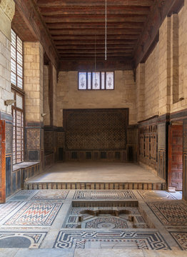 Hall at ottoman era historic house of Moustafa Gaafar Al Seleehdar located at Al Darb Al Asfar District, Cairo, Egypt with decorated wooden ceiling, marble decorated floor and ornate stone walls