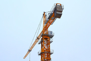 Fototapeta premium Yellow tower crane. Close-up. Background.