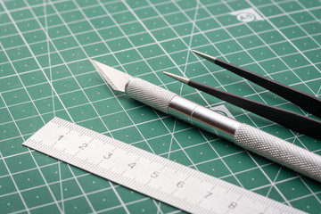 Knife, ruler, tweezers cutting mat