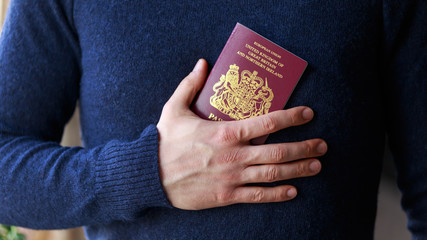 man holding british, european union passports. Devon, United Kingdom, January, 2019