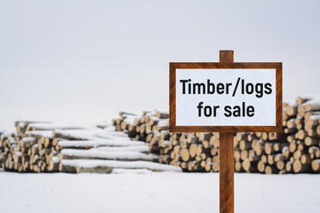 Sign TIMBER/LOGS FOR SALE. Materials for constructing wooden buildings