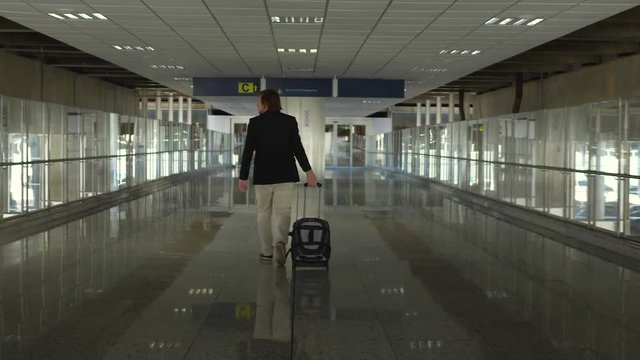 Man walking by the airport, boarding and landing