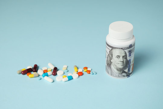 Pills And One Hundred Dollar Bill. Dependence On Drugs. Pharmaceutical Industry, Earnings On Sick People.