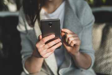 Woman holding cellular in hands and indicate forefinger on display