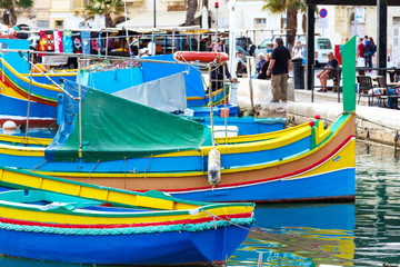 Traditional colourful painted Maltese fishing boats, called luzzu, in the small fishing village Marsaxlokk on Malta.