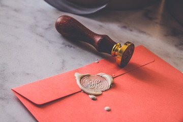 Paper pink envelope with sealing wax stamp and invitation card
