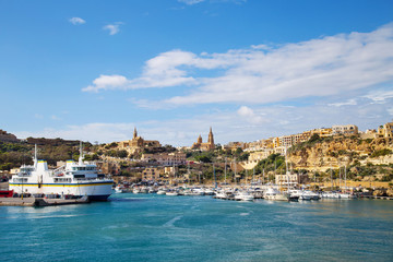 Fototapeta na wymiar Harbour and dock of Gozo island, Malta, called Mgarr. Place where ferries from Malta to Gozo arrive and dock.