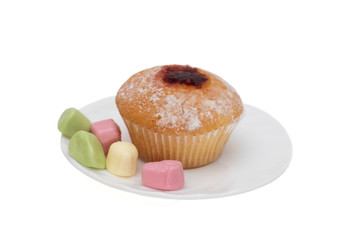 Cupcake and candy on a saucer on white background, isolate