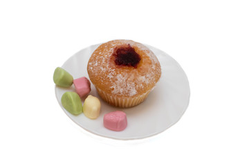 Cupcake and candy on a saucer on white background, isolate
