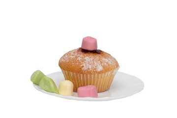 Cupcake and candy on a saucer on white background, isolate