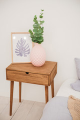 vase on a bedside table in an interior