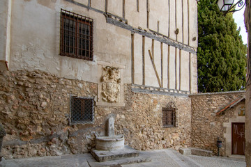 Fototapeta na wymiar Old coat of arms on top of a water source in Cuenca