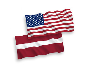 National vector fabric wave flags of Latvia and America isolated on white background. 1 to 2 proportion.