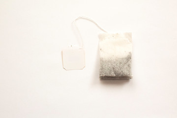 Obraz premium Teabag with red label isolated on a white