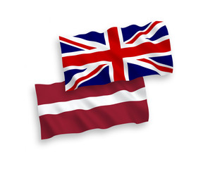 National vector fabric wave flags of Latvia and Great Britain isolated on white background. 1 to 2 proportion.