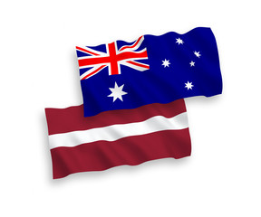 National vector fabric wave flags of Australia and Latvia isolated on white background. 1 to 2 proportion.