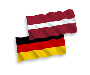 National Vector Fabric Wave Flags Of Germany And Latvia Isolated On White Background. 1 to 2 proportion.